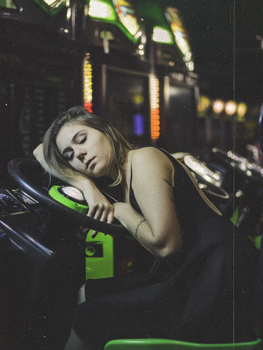 Woman Sleeping on Steering Wheel, arcade, indoors, light, night HD wallpaper