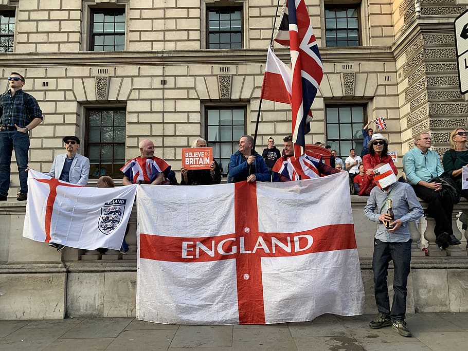people holding England flag, architecture, building exterior