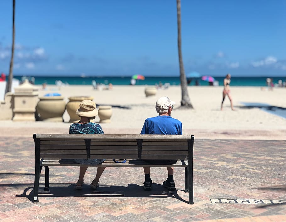 Man and Woman Sitting on Brown Wooden Bench, adult, beach, couple HD wallpaper