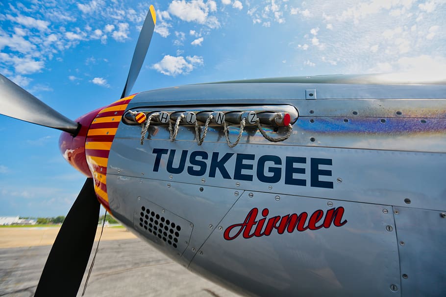 Gray Tuskegee Airmen Airplane Under Blue and White Cloudy Skies at Daytime