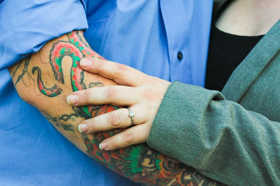 Man With Tattoo With a Woman in Green Top, hand, human, person HD wallpaper