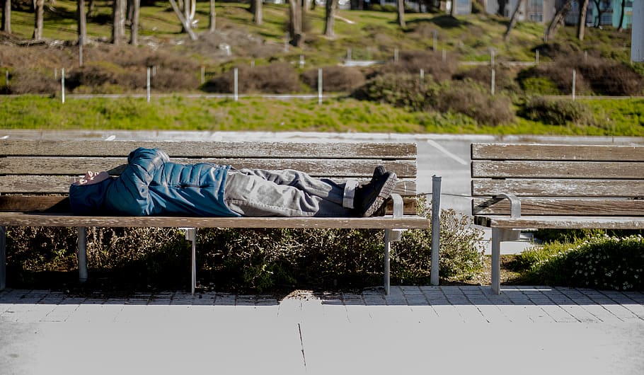 person lying on bench, furniture, human, couch, park bench, bridge