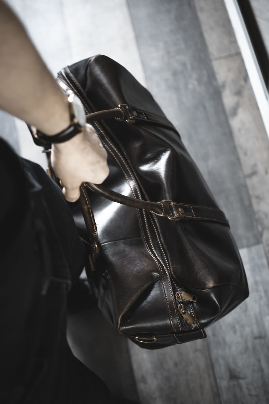 person holding brown leather handbag, accessory, accessories