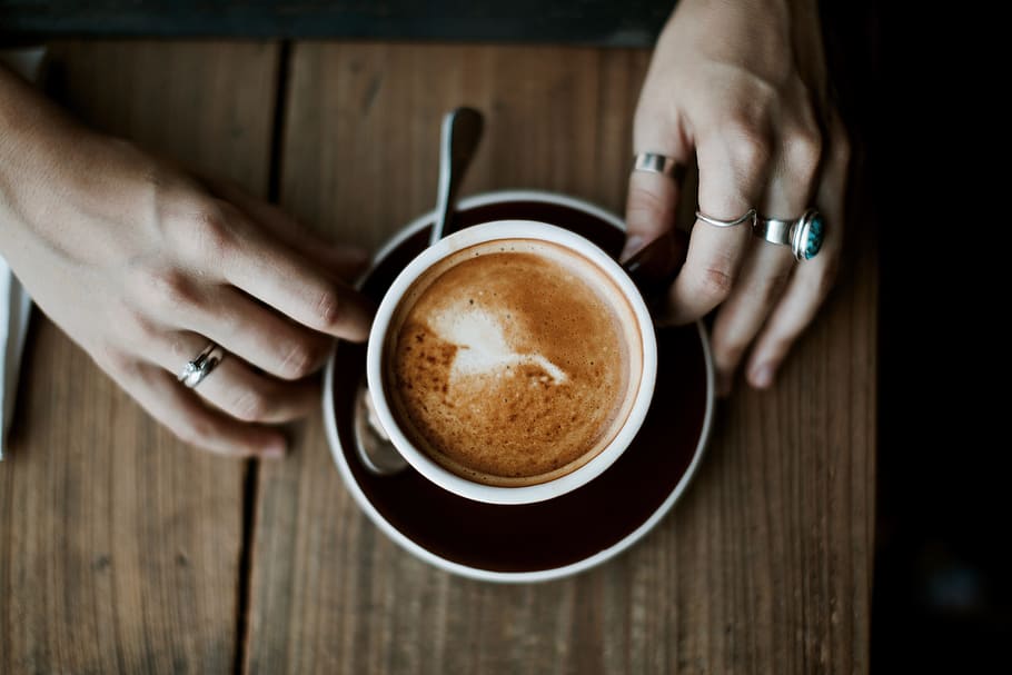 person holding white ceramic cup, capuccino, interior, hand, table HD wallpaper
