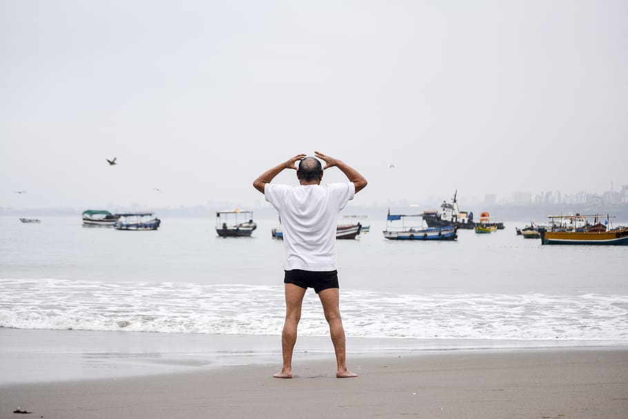 man standing on seashore, water, rear view, one person, sky, beach HD wallpaper