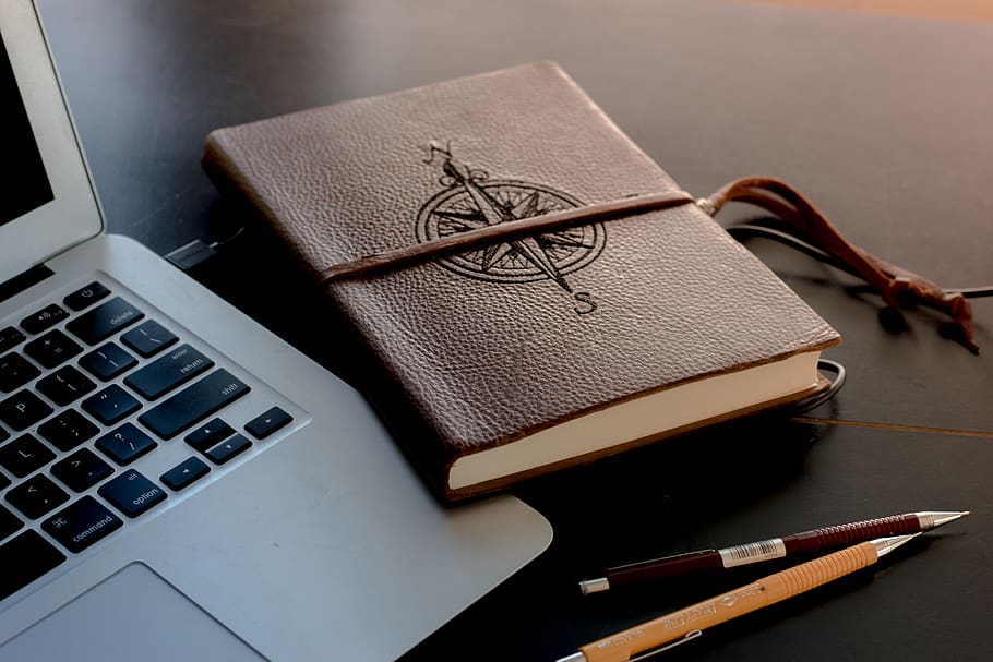 brown book beside MacBook, sweden, keyboard, electronics, laptop HD wallpaper