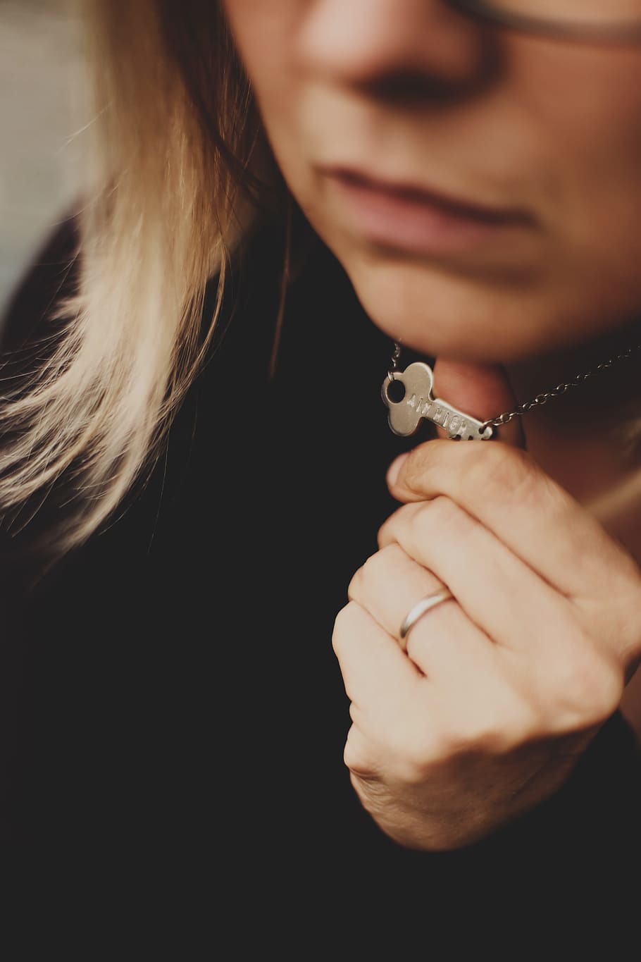 woman in black top holding silver-colored necklace, key, hand HD wallpaper