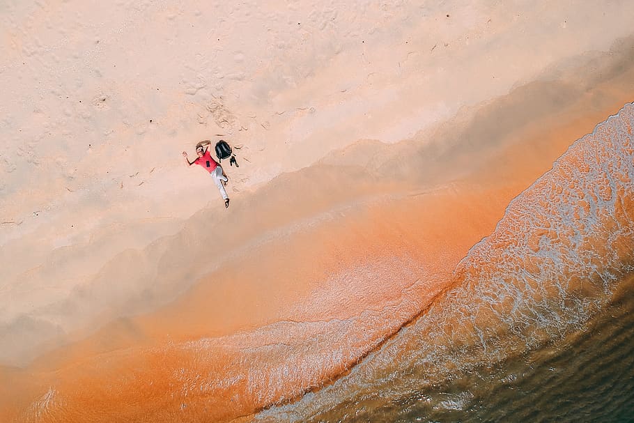 Person Lying Down on Sand, aerial shot, backpack, beach, daylight HD wallpaper