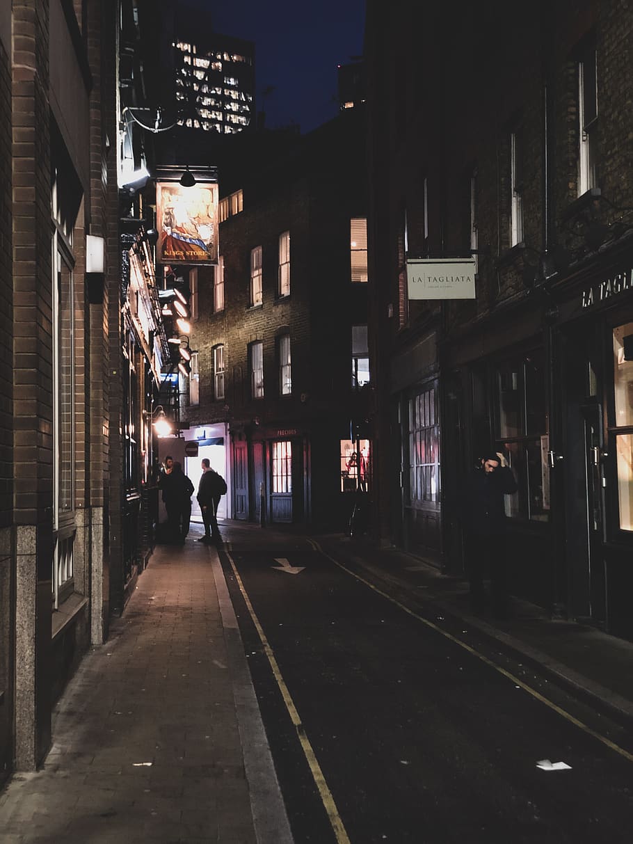 Person Standing on Black Road, architecture, city, commerce, evening HD wallpaper