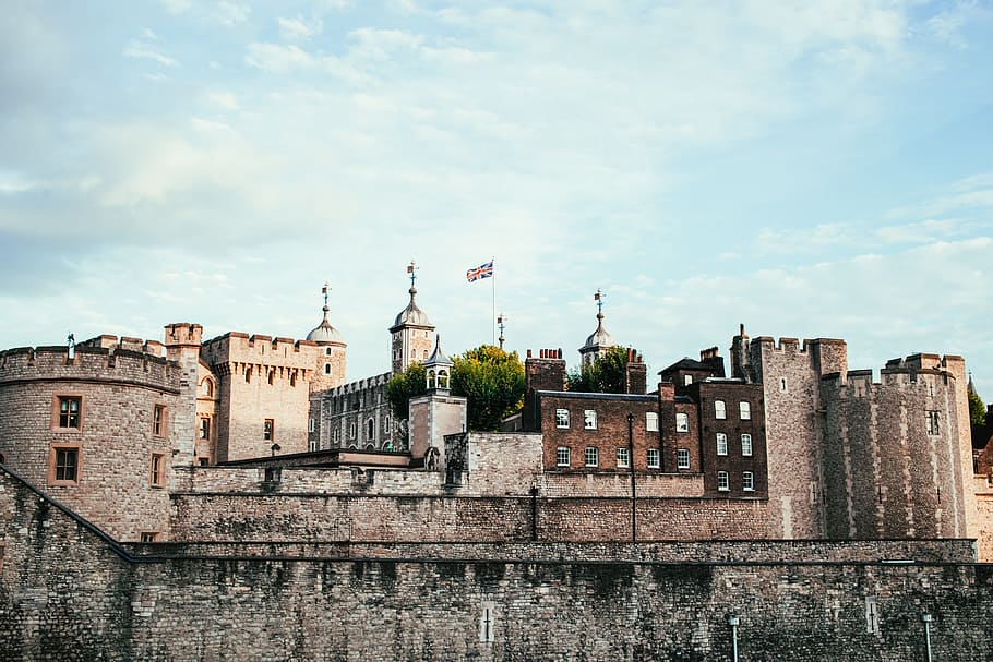 Union jack fluttering above a british castle on a cloudy day HD wallpaper