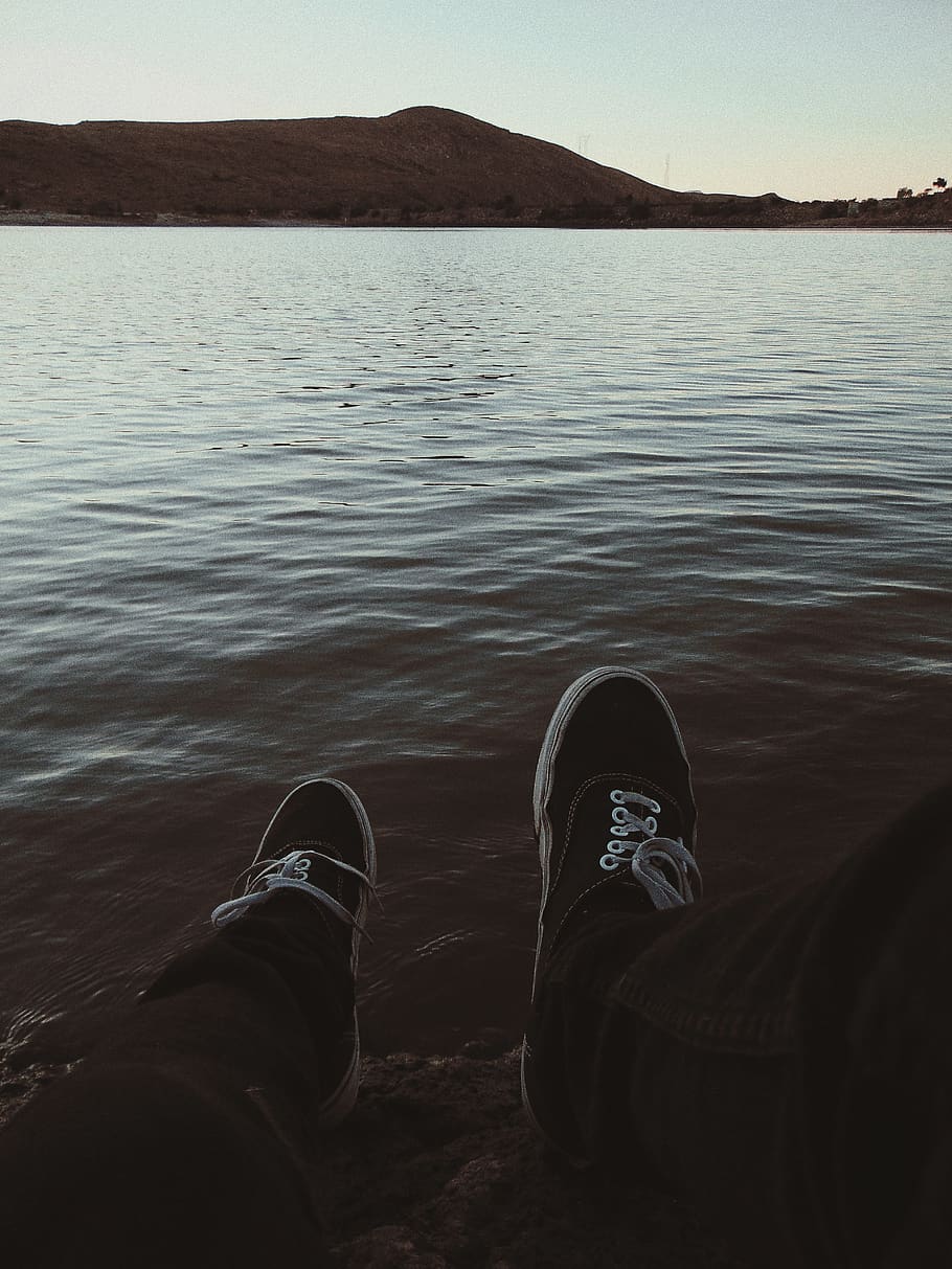 Person Wearing Sneakers Sitting in Front of Ocean, beach, dawn HD wallpaper