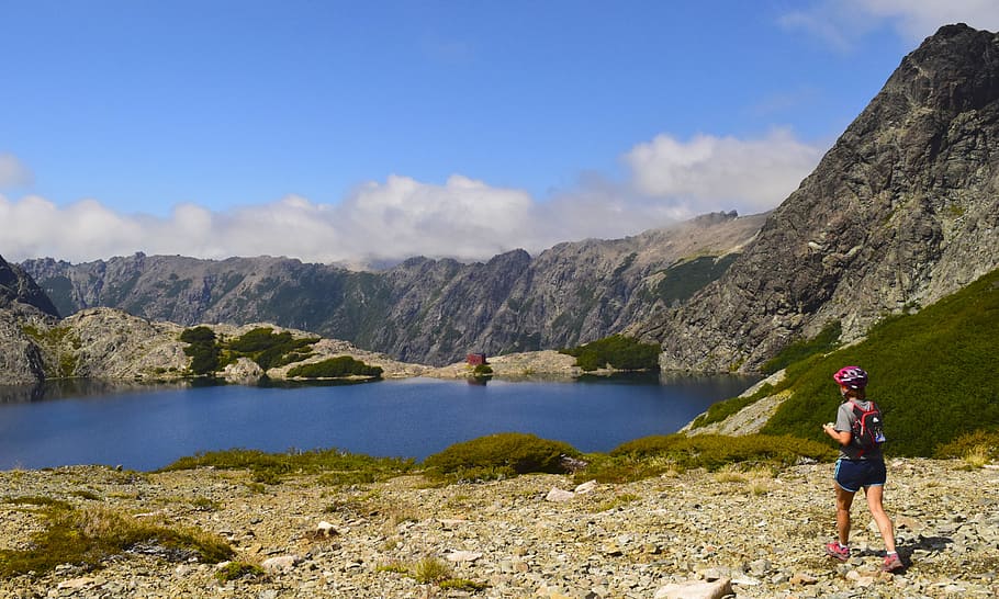 Person Standing Near Lake Under Cloudy Sky, altitude, backpack HD wallpaper