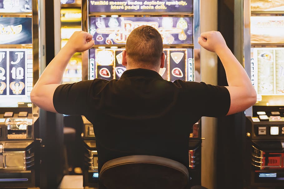 HD wallpaper: Man playing the slot machine at casino, rear view, one person | Wallpaper Flare