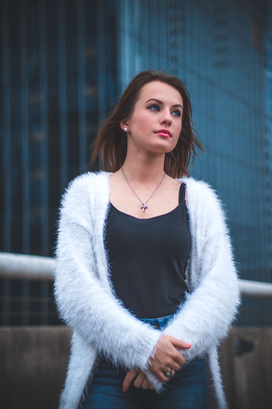 selective focus photo of woman wearing white faux fur cardigan
