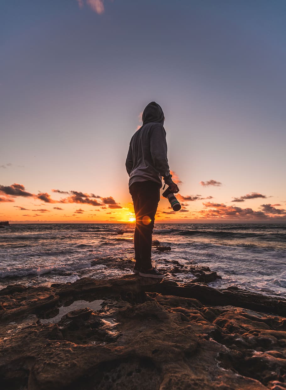 Man Standing on Rock Formation Near Sea during Sunset, camera HD wallpaper