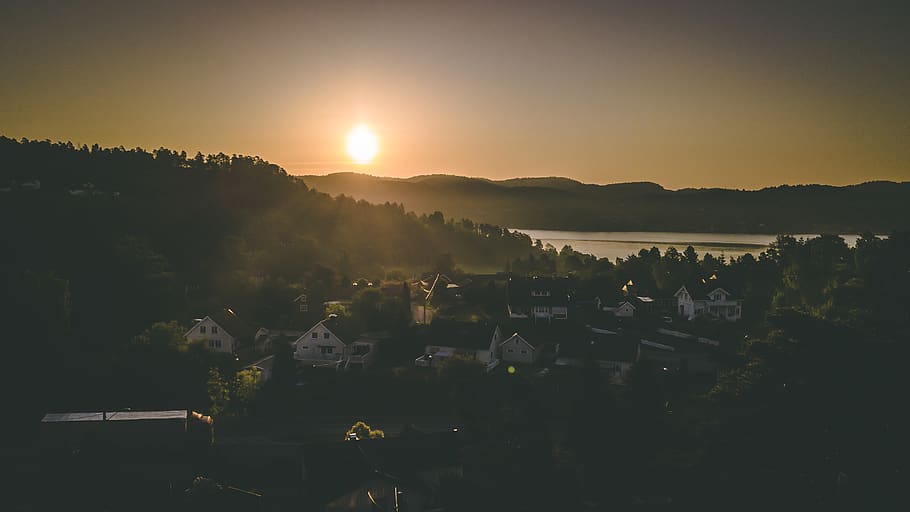 Village Near Mountain And Body Of Water, backlit, dawn, sun, sunrise HD wallpaper