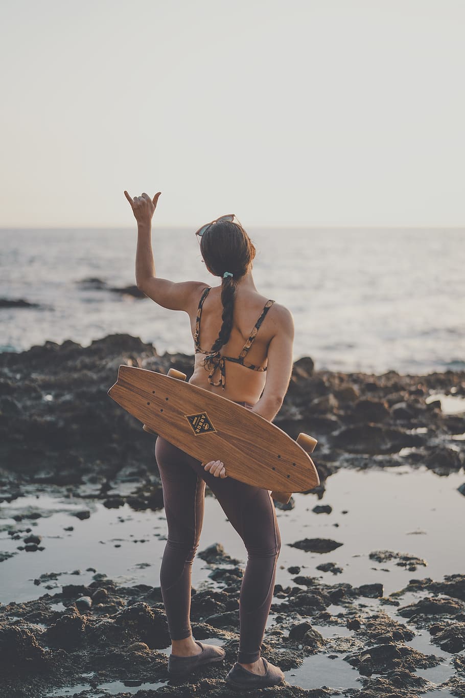 woman holding brown cruiser board, pony tail, coast, sunset, skateboard, HD wallpaper