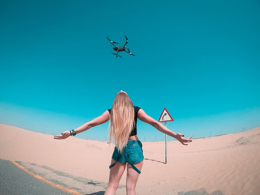 Black Quadcopter Over Woman Wearing Black Shirt, camera, desert, HD wallpaper