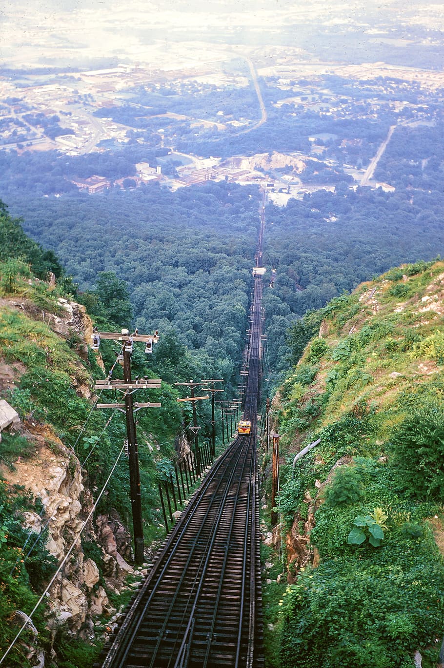 Electric Locomotive Track with train running between mountains in the background HD wallpaper