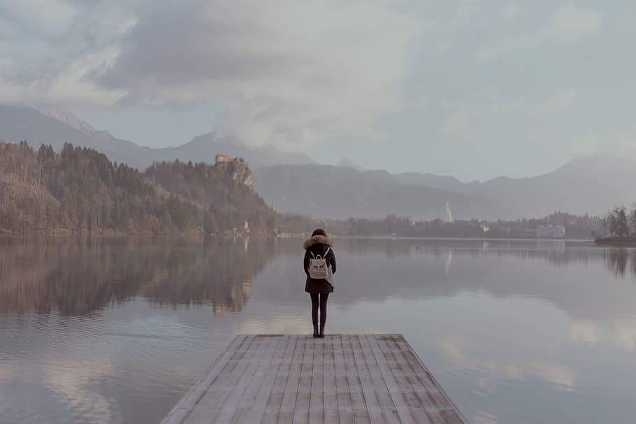 woman standing beside body of calm water, lake, reflection, explore HD wallpaper