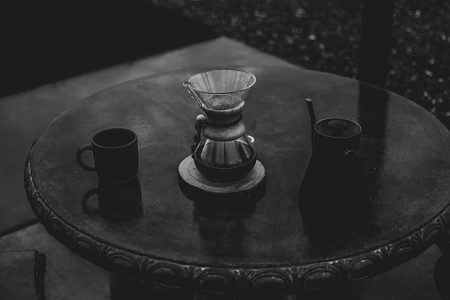 gray scale photo of mugs on round wooden table, tabletop, furniture