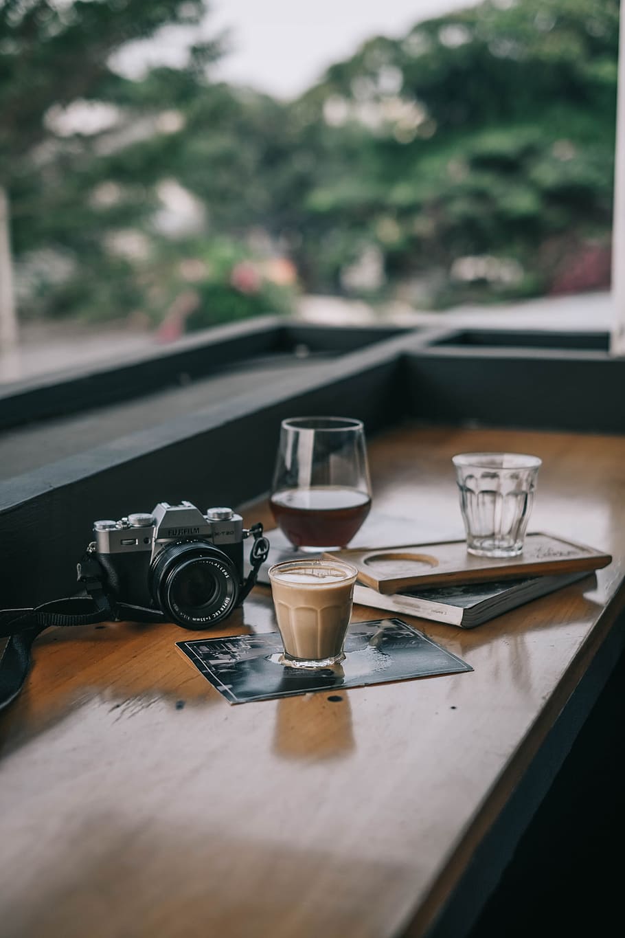 black camera on brown table, cup, coffee, latte, shop, cafe, bokeh