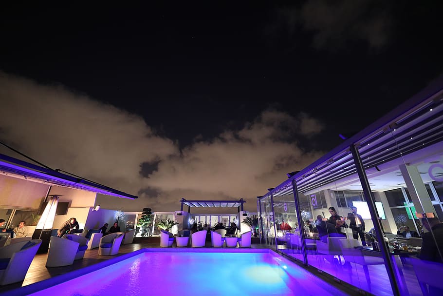 Swimming Pool Surrounded With Tables and Chairs at Night, architecture HD wallpaper