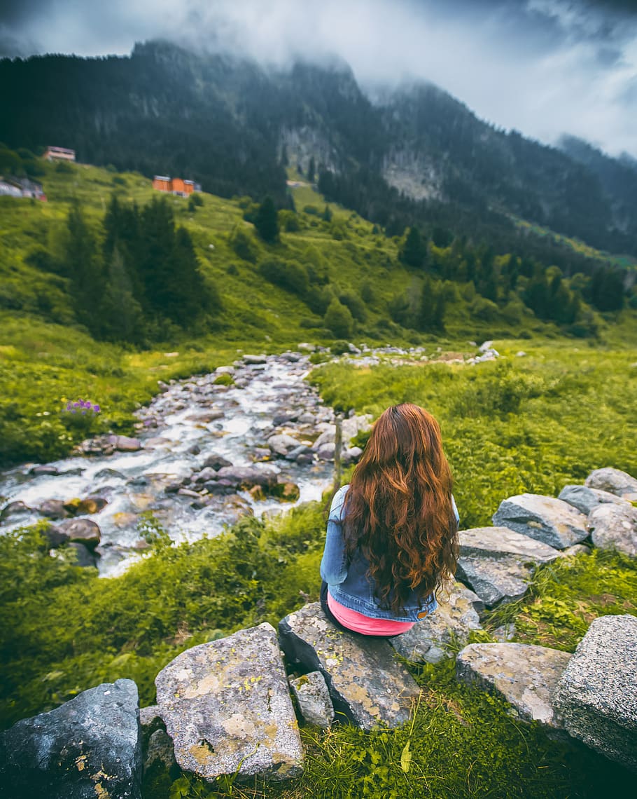 Woman in Denim Jacket Sitting on Rock Facing Mountain, alone HD wallpaper