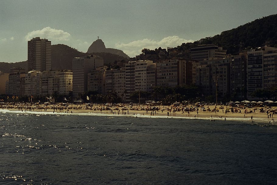 People on Beach Near Buildings, architecture, bay, coast, commerce HD wallpaper