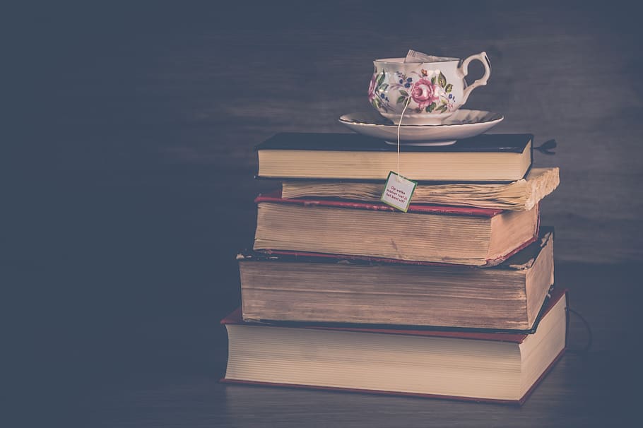 Pile of Hardbound Books With White and Pink Floral Ceramic Teacup and Saucer HD wallpaper