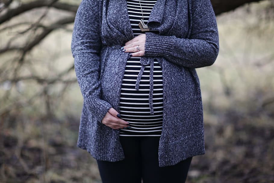 Woman Pregnant in Black and White Striped Shirt Standing Near Bare Tree HD wallpaper