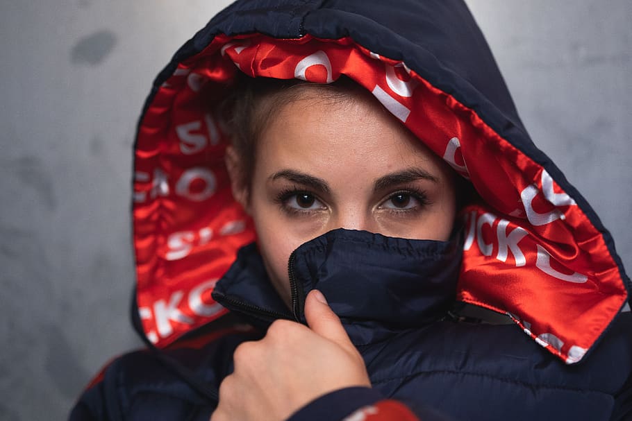 Close-Up Photo of Woman Covering Her Mouth With Her Jacket, beautiful
