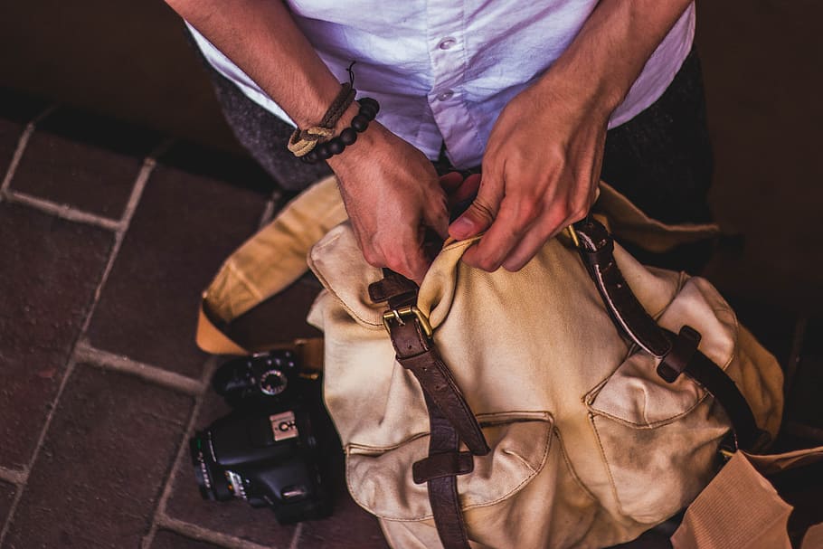 person holding brown bag, backpack, holiday, open, bracelet, above HD wallpaper