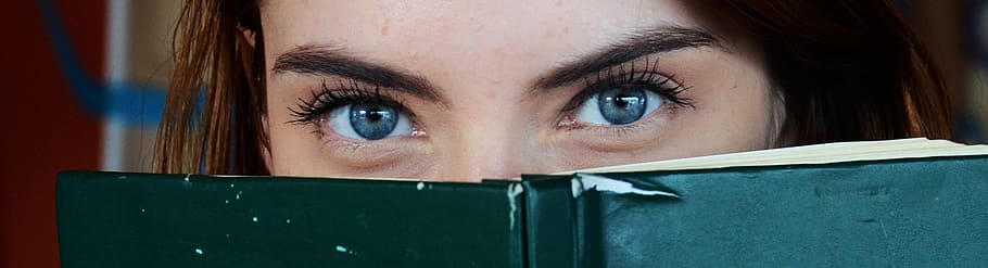 Woman Covering Her Face With Green Book, adult, beautiful, blue eyes