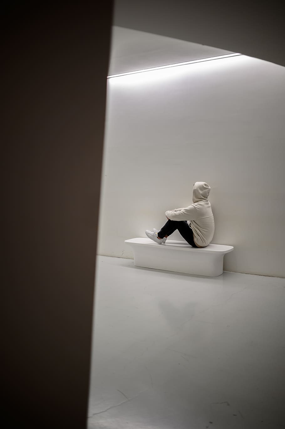 man sitting on white floor, indoors, human representation, white color HD wallpaper