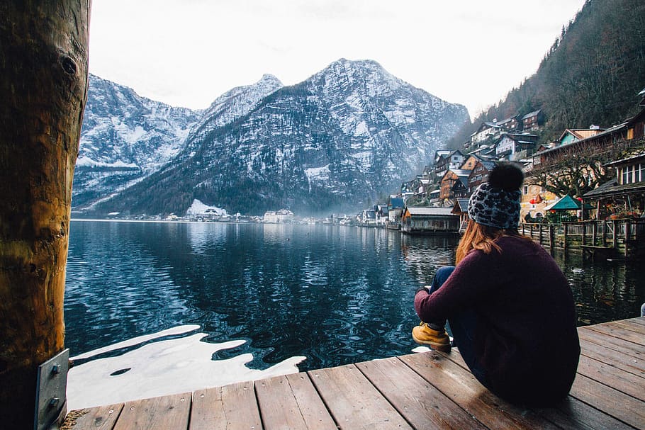 Woman in Purple Sweater Sitting on Wooden Floor With View of Lake and Mountains HD wallpaper
