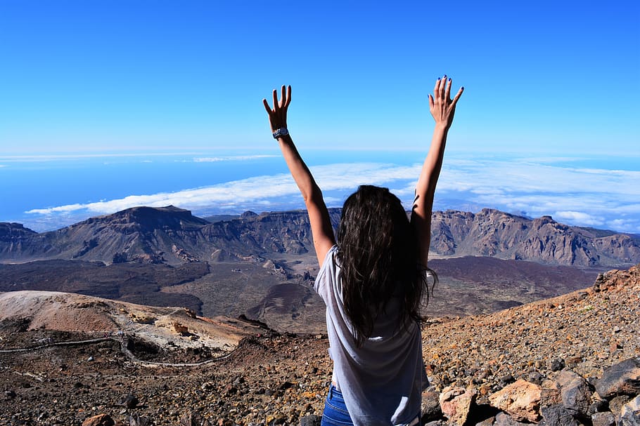 Woman Standing on Mountain While Raising Her Hands, desert, dom HD wallpaper
