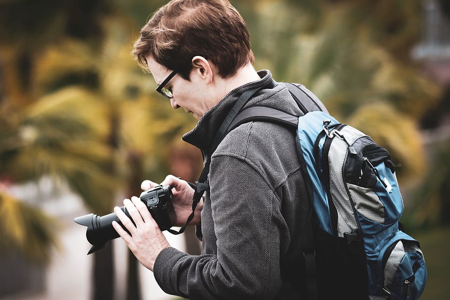 man holding black DSLR camera, human, people, person, photographer HD wallpaper