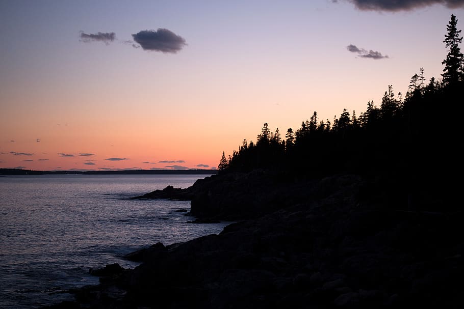 Mountain Silhouette Beside Body of Water Photo during Sunset HD wallpaper