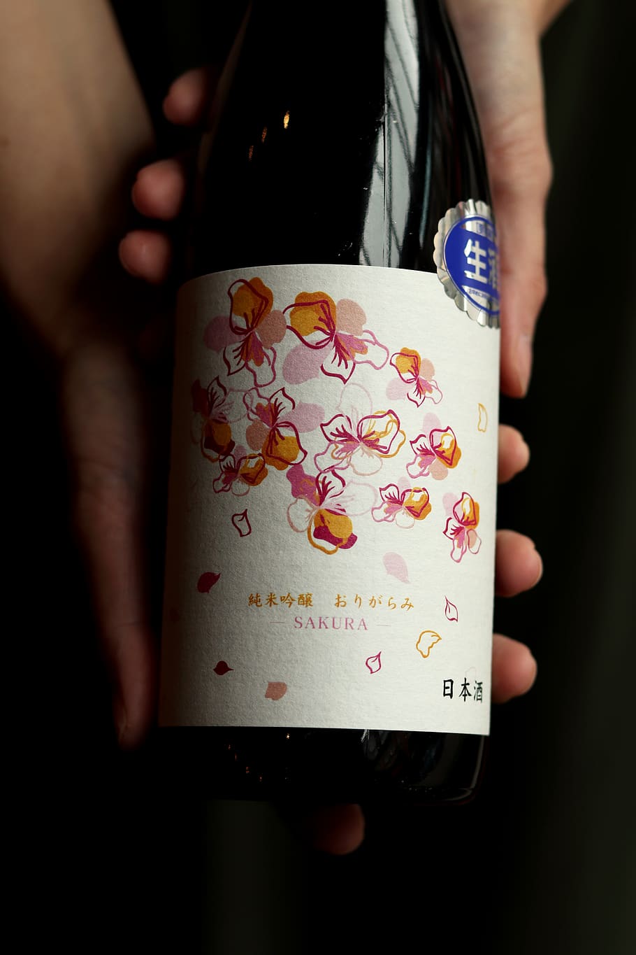 Sakura labeled bottle, human hand, holding, real people, human body part HD wallpaper