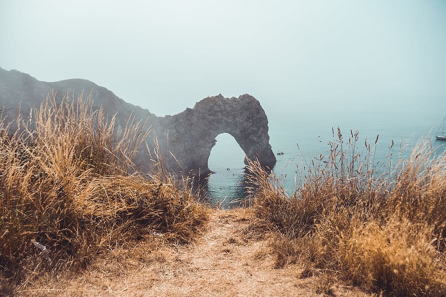 beach grass beside body of water, rock, arch, formation, outdoors HD wallpaper