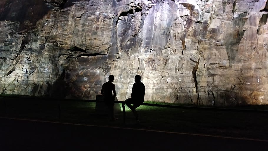 silhouette, cliffs, night, light, spotlight, humans, real people HD wallpaper