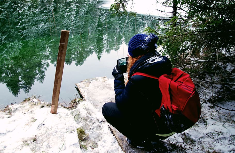 Person Carrying Red Backpack Capturing Photo Of Body Of Water HD wallpaper