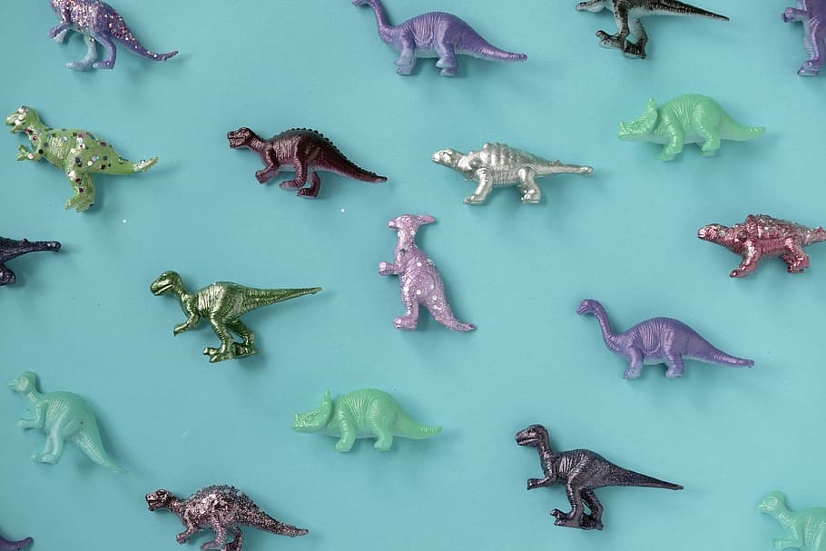 Assorted-color Plastic Dinosaur Figurine Lot on Teal Surface, HD wallpaper
