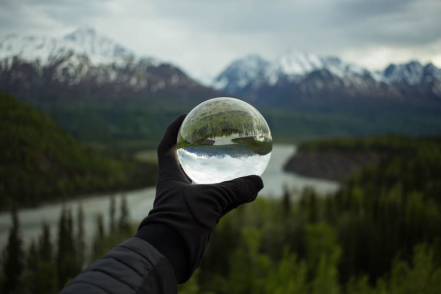 person holding glass globe, lens ball, hand, reflection, mountain HD wallpaper