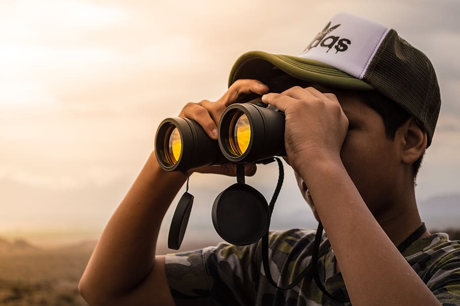 Man Looking in Binoculars during Sunset, cap, clouds, daylight HD wallpaper