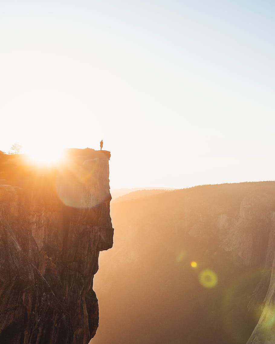 person standing on cliff during daytime, mountain, sunset, sunrise HD wallpaper