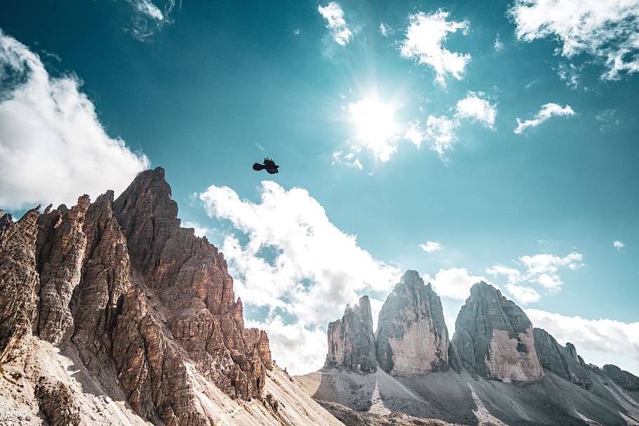 flight of bird above brown mountain, sky, cloud, rock, formation HD wallpaper