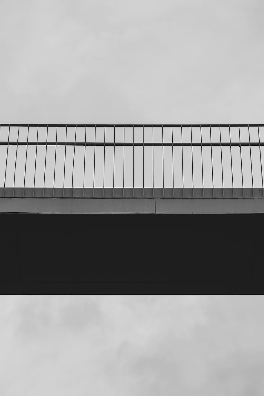 low-angle photography of gray concrete bridge, road, building