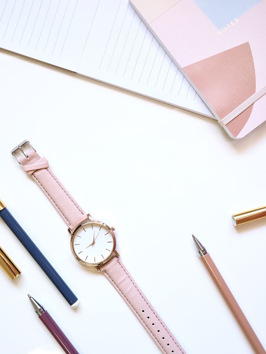 round gold-colored analog watch, notepad, pink, business, minimal
